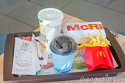 McRib sandwich, french fries, Sprite and cup with tea in German McDonald`s Editorial Stock Photo