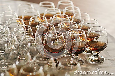 Konjac rows on table at wedding reception. Cocktails and whiskey in glasses at alcohol bar at wedding or christmas feast. Luxury Stock Photo