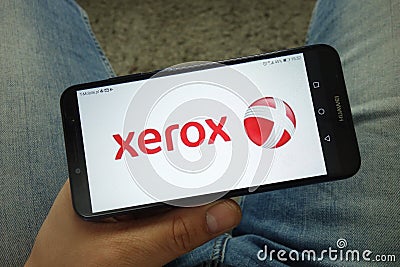 Man holding smartphone with Xerox Corporation logo Editorial Stock Photo