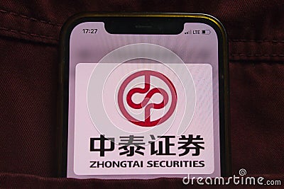 KONSKIE, POLAND - February 22, 2022: Zhongtai Securities company logo on mobile phone hidden in jeans pocket Editorial Stock Photo