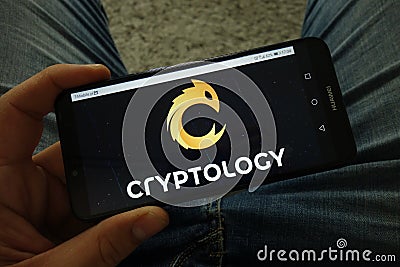 Man holding smartphone with Cryptology cryptocurrency exchange logo Editorial Stock Photo