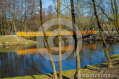 Konstancin-Jeziorna, Poland - Early spring forest and water ponds landscape with wooden footbridge in Konstancin-Jeziorna Springs Stock Photo
