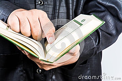 Koran in hand - holy book of Muslims ( public item of all muslims ) Stock Photo