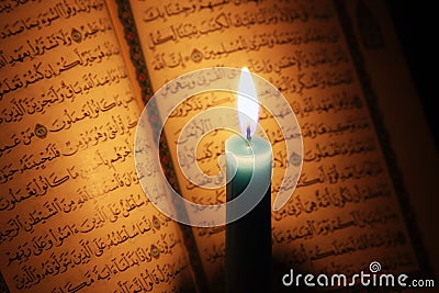 Koran or quran holy book with candle on candlelight Stock Photo