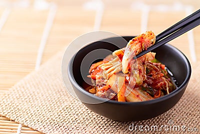 Korean food, Kimchi cabbage eating with chopsticks Stock Photo