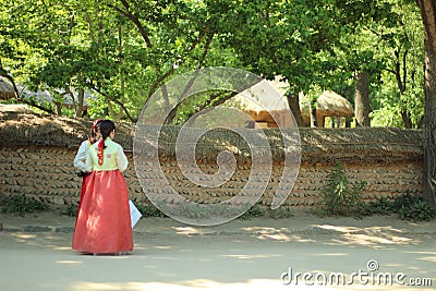 Korean girls standing outside traditional Korean houses Editorial Stock Photo