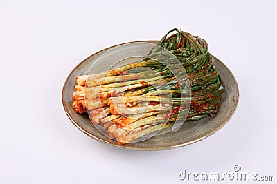 Korean green onion kimchi on plate on white background Stock Photo