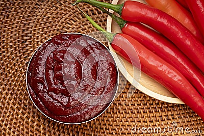 Korean pepper paste and red pepper in wooden plate, Gochujang Korean traditional Chili paste on a wooden table background. Stock Photo