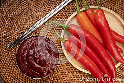 Korean pepper paste and red pepper in wooden plate, Gochujang Korean traditionl Chili paste on a wooden table background. Stock Photo