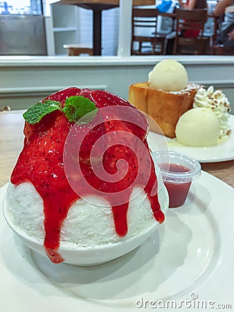 Korean shaved ice topped with strawberry syrup, Bingsu or Bingsoo Stock Photo