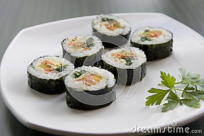 Korean sushi and a parsley leaf. Stock Photo