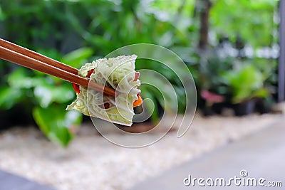 Korean traditional grilled BBQ food, samgyupsal, pork grilled in Lettuce with Chopsticks, Food for camping in winter Stock Photo