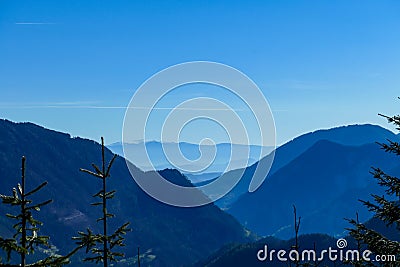 Kosmatitza - Panoramic view of misty Karawanks mountain range on sunny day in Carinthia, Austria Stock Photo