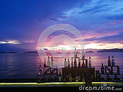 Beautiful sunset sea view with wine bottles decorated at the drinking bar Editorial Stock Photo