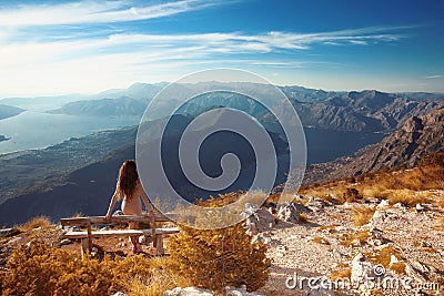 Kotor bay. Montenegro. Romantic Woman on bench above Landscape o Stock Photo