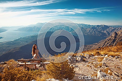 Kotor bay. Montenegro. Romantic Woman on bench above Landscape o Stock Photo
