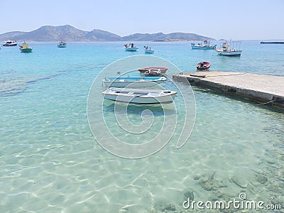 Small fishing boats in crystal waters sea Stock Photo