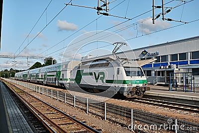 Train on the station. Train with double-deck passenger coaches. Editorial Stock Photo