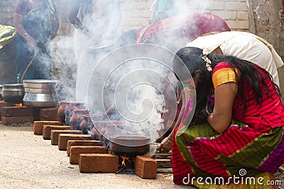 KOVALAM, KERALA, INDIA, April 1, 2015: Some women devotees participate in Pongala ceremony where boiled rice made in Editorial Stock Photo