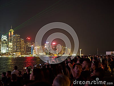 Large groups of people gather at the pier of Kownloon to admire the spectacle A Symphony Editorial Stock Photo