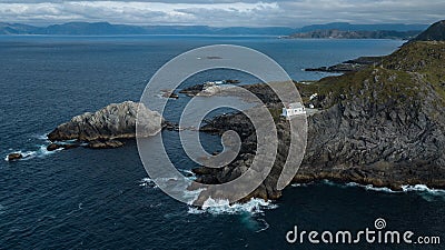 Kraakenes lighthouse on rocky beach, in Vaagsoy, Norway 2018 Stock Photo