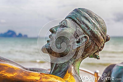 Krabi Thailand July 2018. Article catching marlin on the beaches of Ao Nang. Part of the sculpture of a fisherman`s head against Editorial Stock Photo