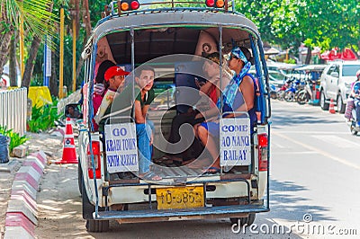KRABI, THAILAND - 12 May 2016: Tourist shuttle public taxi parked on the public roadway along the beach in Ao Nang town Editorial Stock Photo