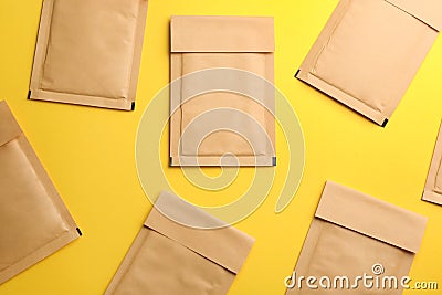 Kraft paper envelopes on yellow background, flat lay Stock Photo