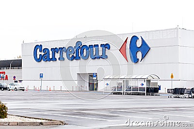 Krakow, Poland, Carrefour supermarket store front logo signage closeup. Empty parking in front of the store building, nobody Editorial Stock Photo