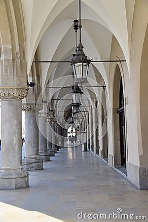 Krakow, Poland. Cloth Hall, Main Square, Krakow Poland. Arches over walkway with lamps overhead. Editorial Stock Photo