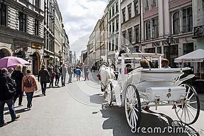 KRAKOW, POLAND 10.05.2015 Horse carriages at main square on a summer day Editorial Stock Photo