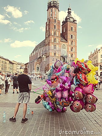 Male street vendor sells colorful popular cartoon character heli Editorial Stock Photo