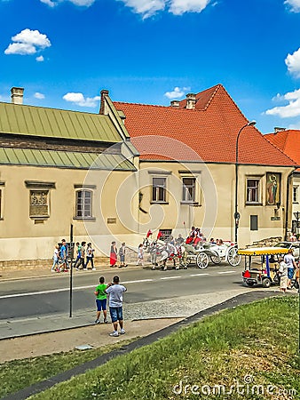 Krakow, Poland - June 215, 2017: A horse-drawn carriage ride along Podzamche Street in Krakow. Krakow is the second largest and on Editorial Stock Photo