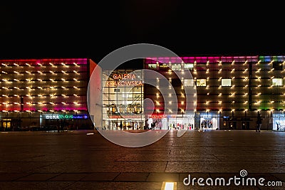 Beautiful and colorful glowing facade of Krakow shopping mall over main railway station at dark Editorial Stock Photo