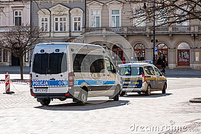 Krakow, Poland, municipal police or city guards and regular police cars on the street, Main Market Square. Public safety services Editorial Stock Photo