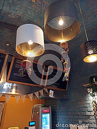 Krakow, Poland - October 19, 2019: Interior of Indian masala roll street food place with warm tone lighting from the light bulb in Editorial Stock Photo