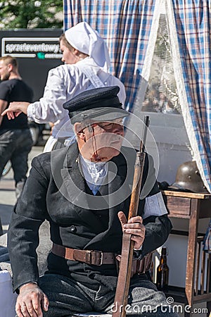 Krakow, Poland - September 23, 2018: ninjured Man dressed in Polish uniforms costume from World War I, holding a shotgun Editorial Stock Photo