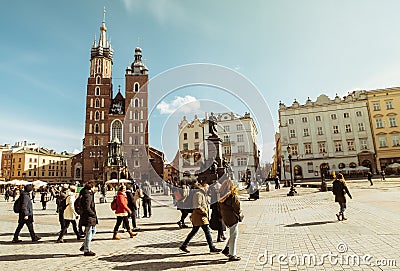 Krakow, Poland - 6th march, 2023: guide with tour group walk together in main square in Krakow. Free tourist walking tours with Editorial Stock Photo