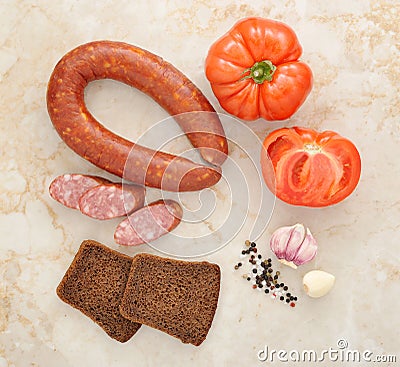 Krakow sausage, tomatoes and black bread Stock Photo