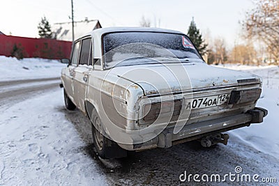 Krasnoyarsk, Russia, August 10, 2019: Russian retro Lada 2106 car on the street abandoned or stolen. behind Editorial Stock Photo