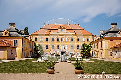 Krasny Dvur Chateau, North Bohemia, Czech Republic, 19 June 2021: Baroque yellow castle with stairs, front yard with green lawn Editorial Stock Photo