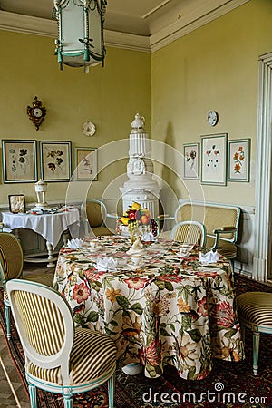 Krasny Dvur Chateau, North Bohemia, Czech Republic, 19 June 2021: Castle interior, white rococo furniture in dining room, table Editorial Stock Photo
