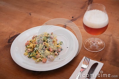 Krautfleckerl, Austrian pasta with caramelized cabbage, Served with Beer Stock Photo