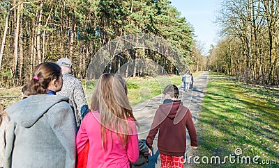 Children walking in the woods for a walk. Back view Editorial Stock Photo