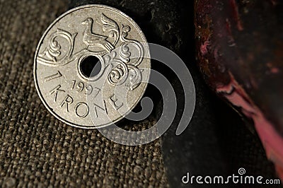 1 Krone Harald V. Norwegian coin and stones on natural linen fabric. Business and finance. Stock Photo