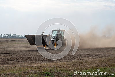 Kropivnitskiy, Ukraine April 20, 2019: The JCB bucket loader in motion at a demonstration site agro exhibition AgroExpo. Tractor Editorial Stock Photo