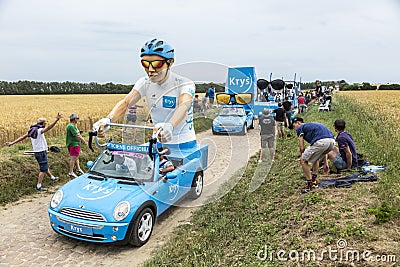 Krys Caravan on a Cobblestone Road- Tour de France 2015 Editorial Stock Photo