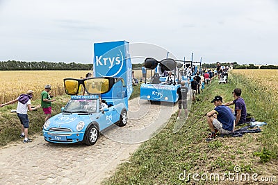 Krys Caravan on a Cobblestone Road- Tour de France 2015 Editorial Stock Photo