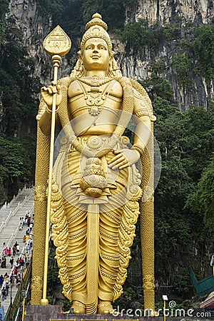 Huge and golden Hindu statue of lord Murugan at Batu caves in Kuala Editorial Stock Photo