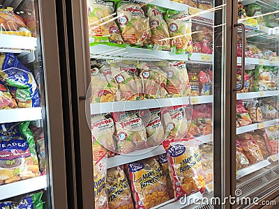 Frozen food displayed on the rack inside the large chiller in the supermarket. Editorial Stock Photo